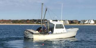 small fishing boat underway on open water