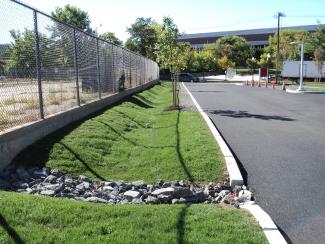 entry driveway next to a chain link fence