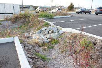 grass and dirt area in a parking lot